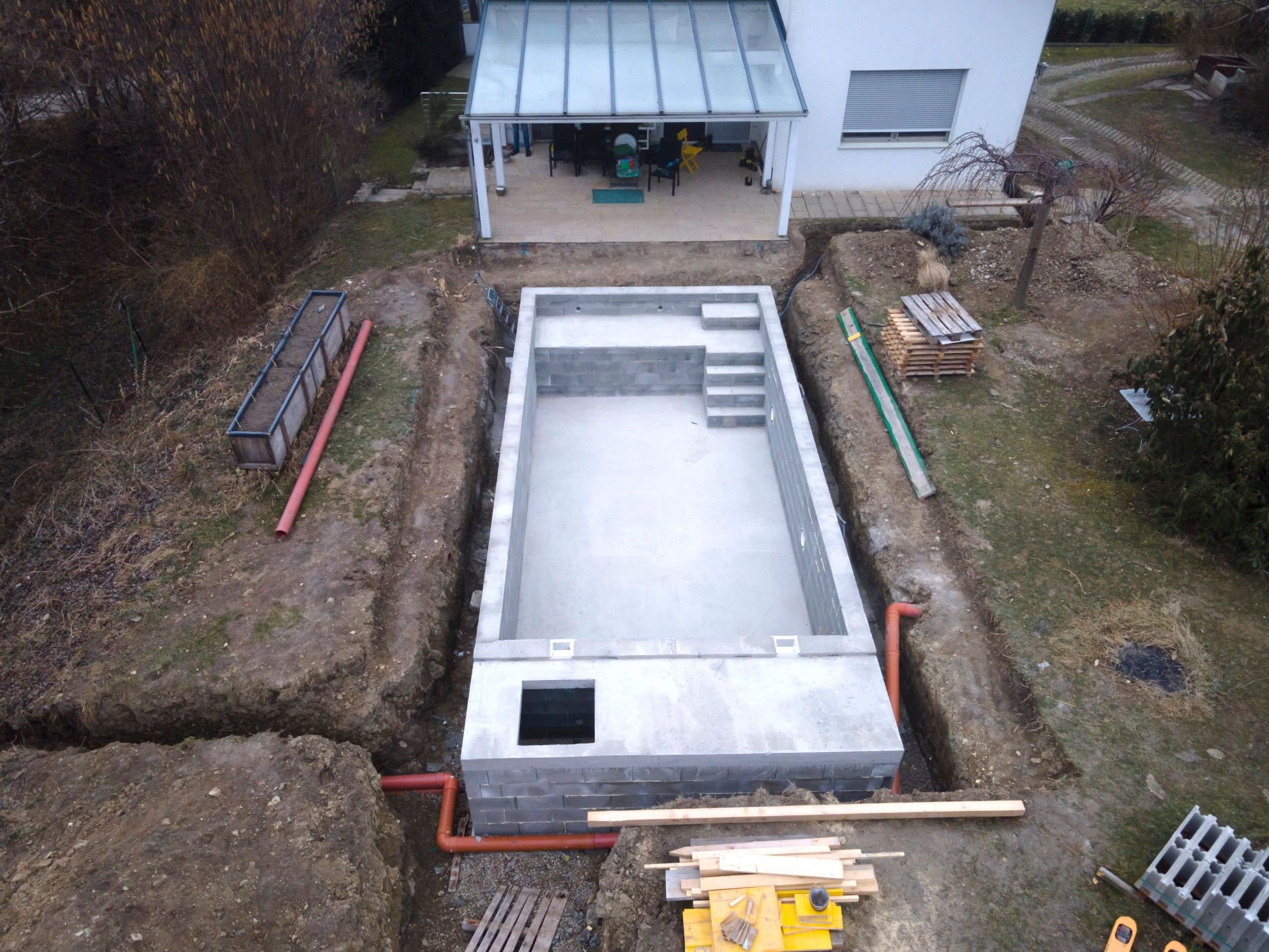 Unfinished swimming pool project in backyard